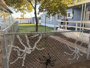 Fenced backyard with an outbuilding
