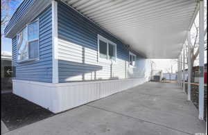 View of property exterior featuring a carport