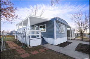 View of property exterior featuring a gate