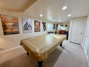 Game room with a textured ceiling, light colored carpet, billiards, and recessed lighting