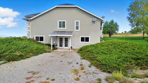 Side view of house with stucco siding, french door walk out, and a patio area