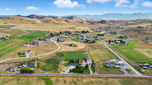 Aerial view of property and surrounding area with mountains and rural landscape