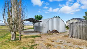 View of outdoor structure with a carport