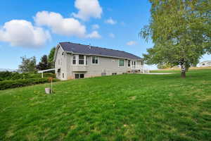 Back of property featuring a yard