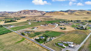 Aerial overview of property's location featuring rural landscape and a mountainous background