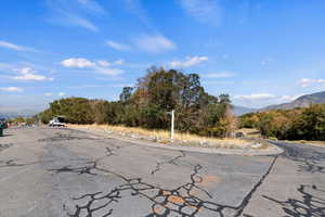 View of asphalt street featuring a mountain view