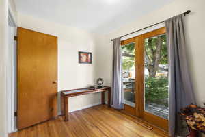 Entryway featuring hardwood / wood-style floors and baseboards