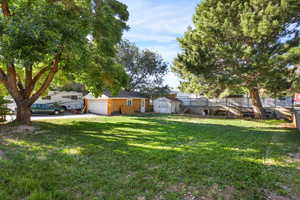 View of yard featuring a storage unit and a garage