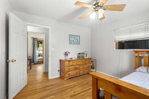 Bedroom with light wood finished floors and ceiling fan