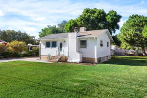 View of front facade with a chimney and roof with shingles