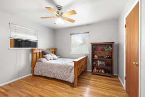 Bedroom featuring a ceiling fan and light wood-style floors