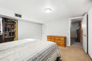 Bedroom featuring light carpet and baseboards