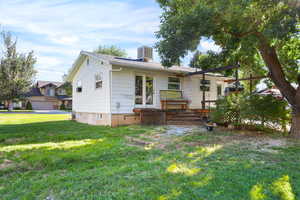 Back of property with a yard