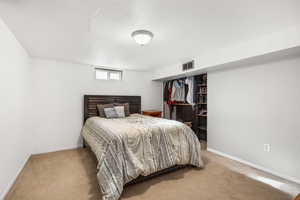 Carpeted bedroom with baseboards