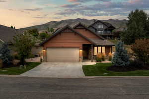 Craftsman inspired home on a corner lot featuring beautiful landscaping and 2-car garage.
