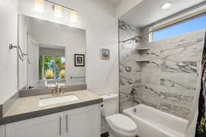 Bathroom featuring shower / bath combination with curtain and vanity