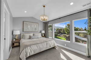 Carpeted bedroom featuring lofted ceiling, a chandelier, recessed lighting, and a mountain view