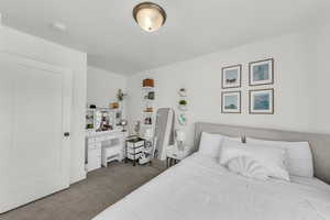 Carpeted bedroom with a textured ceiling