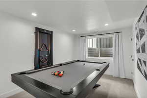 Recreation room with pool table, light colored carpet, and recessed lighting