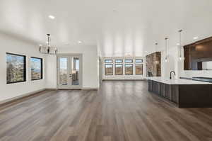 Spacious great room with unobstructed views and French doors leading to covered deck.