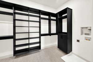 Master suite walk-in closet with washer/dryer hookups.