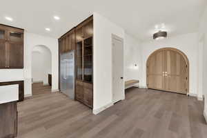 Inviting foyer with hand crafted entry door and bench.