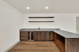 Rec room wet bar with floating shelves.