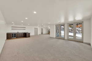 Walk-out basement recreation room with wet bar.  French doors lead to covered patio and secondary patio which is hot tub ready.