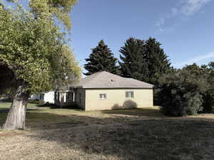 View of side of home featuring a yard and brick siding