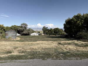 View of yard featuring a rural view and a mountain view