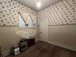 Entryway with hardwood / wood-style flooring and wallpapered walls