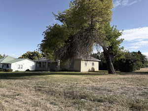 View of front of property featuring brick siding and a front lawn