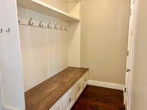 Mudroom with dark wood-type flooring and baseboards