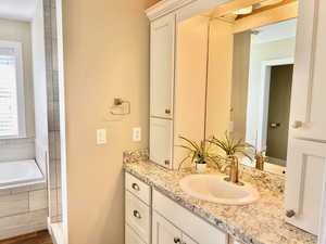 Bathroom with vanity and a garden tub