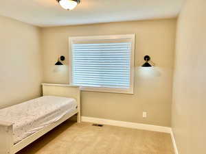 Carpeted bedroom featuring a textured ceiling