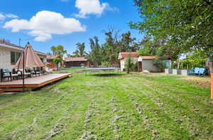 Backyard with a shed and deck. Sheds (2) included.