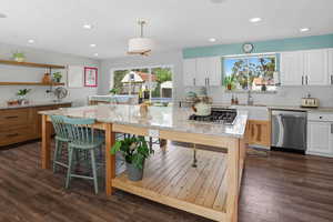 Open kitchen with granite countertops. Customized island.