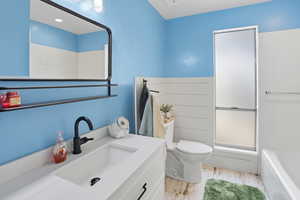 Full bathroom with light wood finished floors, vanity, and bathing tub / shower combination