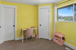 Home office featuring carpet and baseboards