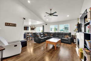 Living area featuring wood finished floors, recessed lighting, high vaulted ceiling, and ceiling fan.