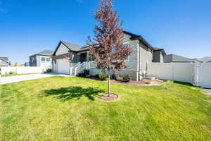 View of front of home with concrete driveway, an attached garage, and solar panels