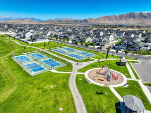Aerial view of residential area featuring mountains and a park