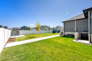 Fenced backyard with a residential view and a trampoline