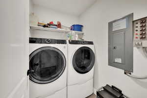 Laundry room with electric panel and independent washer and dryer