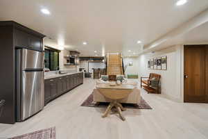 Dining area with recessed lighting, light wood finished floors, and stairs