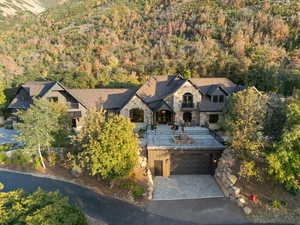 Aerial view of property and surrounding area with a heavily wooded area