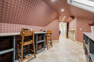 Bonus room featuring lofted ceiling, wallpapered walls, light flooring, and recessed lighting