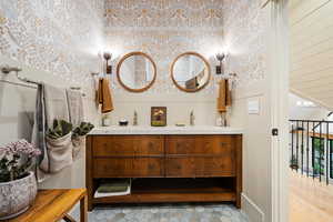Bathroom featuring vanity and wallpapered walls