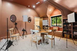 Dining space featuring lofted ceiling and recessed lighting