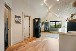 Unfurnished living room featuring light wood-style floors, high vaulted ceiling, recessed lighting, and wooden ceiling